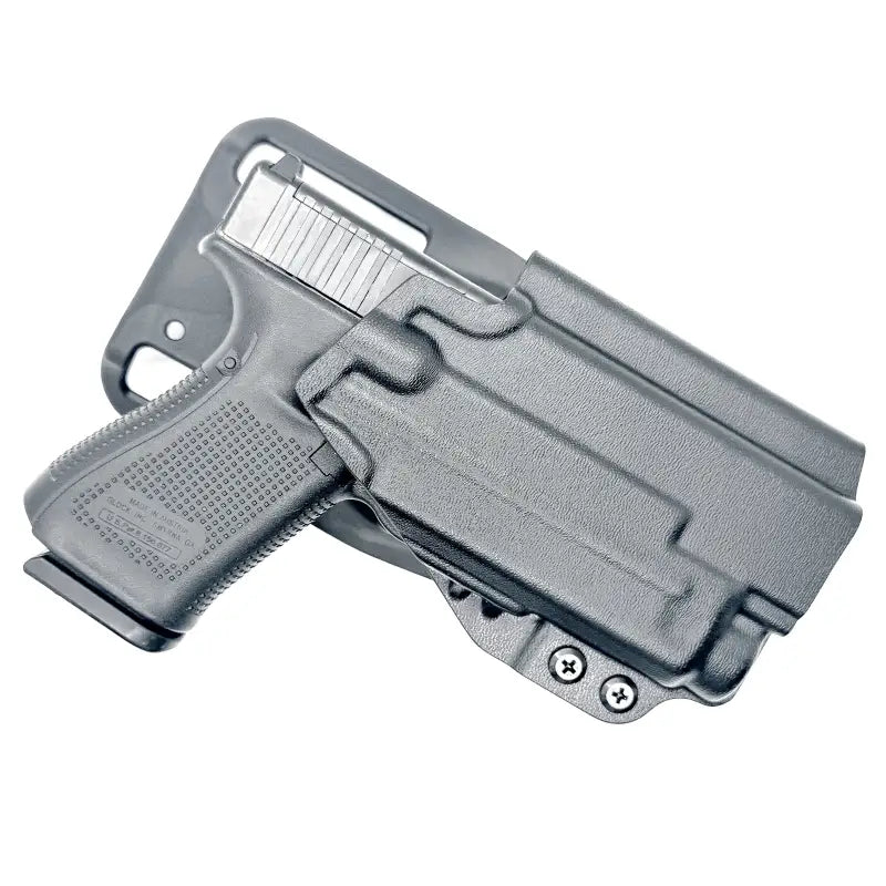 Black pistol in a holster with Nightstick TCM-10 for competition and weapon lights