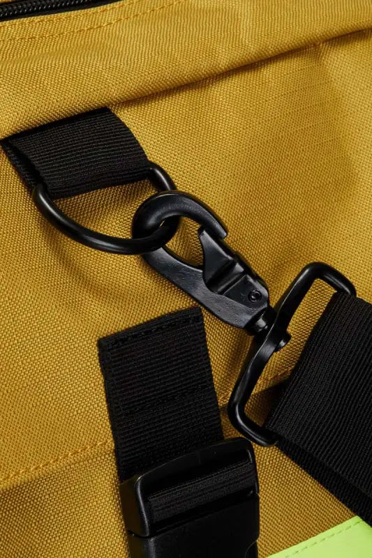 Black plastic buckle clip on yellow fabric for Elite Firefighter Gear Bag