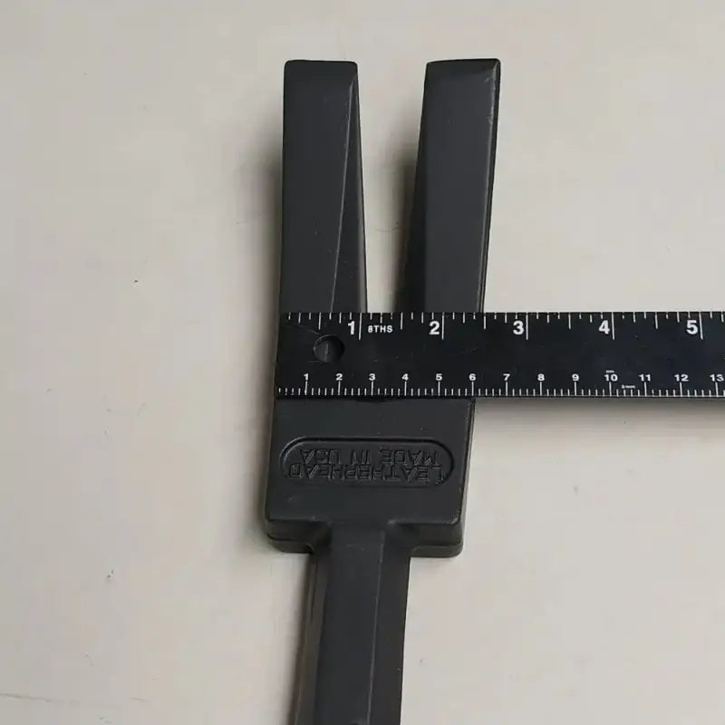 Black plastic measuring tool with ruler markings for Leatherhead Tools Halligan Entry Tool