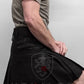 Black pleated utility kilt with cargo pockets displayed on a model wearing Standard Blackout Utility Kilt