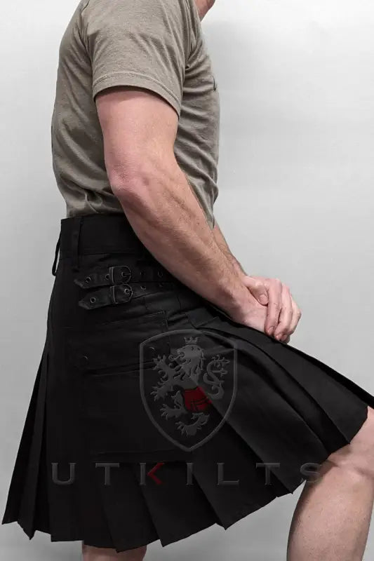 Black pleated utility kilt with cargo pockets displayed on a model wearing Standard Blackout Utility Kilt