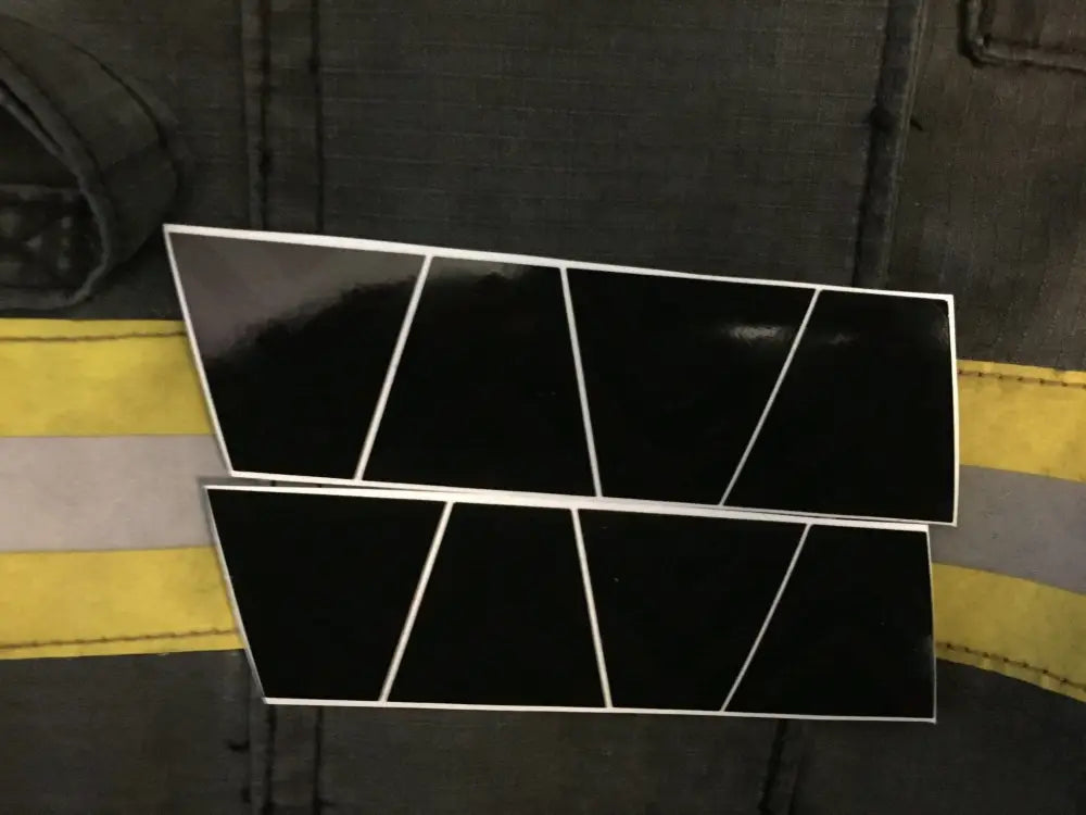 Black and green chevron reflective helmet with black panels and diagonal lines