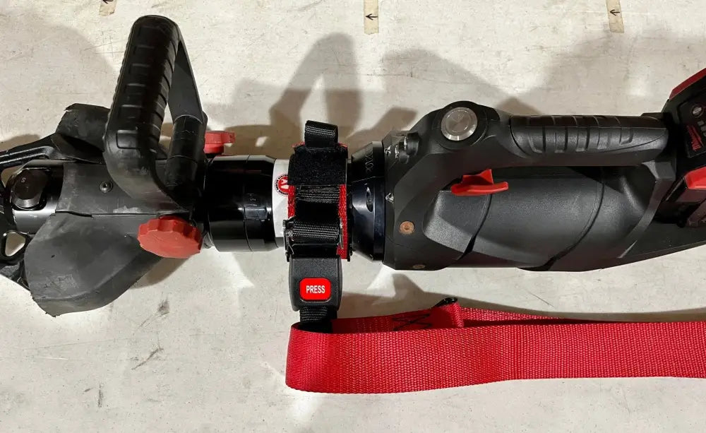 Black and red electric scooter handlebars with controls for Genesis 11C extrication tool carrying