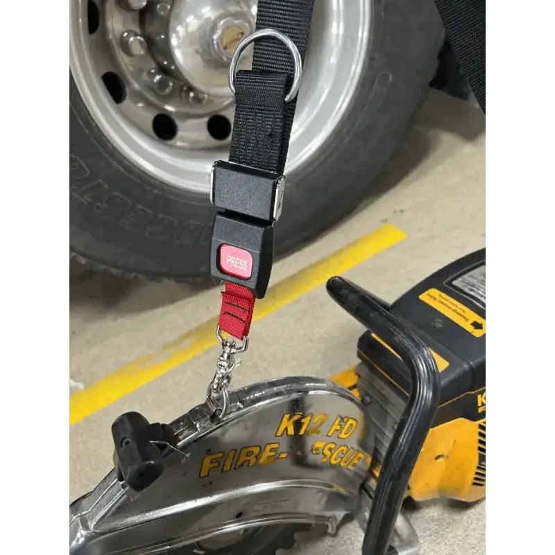 Black and red carrying strap-K12 with spring clips attached to a tire and wheel