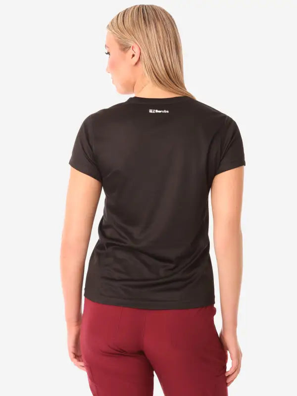 Back view of a black women’s short-sleeve underscrub t-shirt for versatile styling