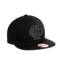 Black snapback baseball cap with dark monogram logo from IDLH Scramble collection