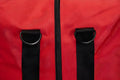 Black straps and zipper detail on red fabric of Deluxe Step-In Firefighter Gear Bag
