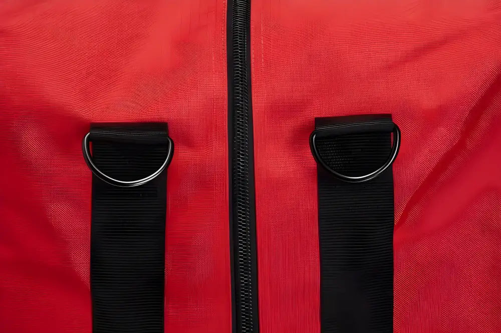 Black straps and zipper detail on red fabric of Deluxe Step-In Firefighter Gear Bag