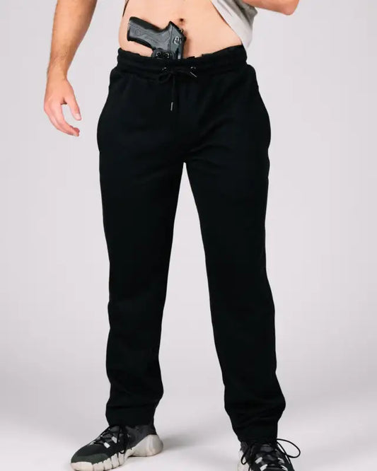 Black sweatpants with patented carrier retention waistband and gun tucked in waistband