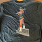 Black level tee featuring a cartoon firefighter on the back from Combat Challenge Firema’am