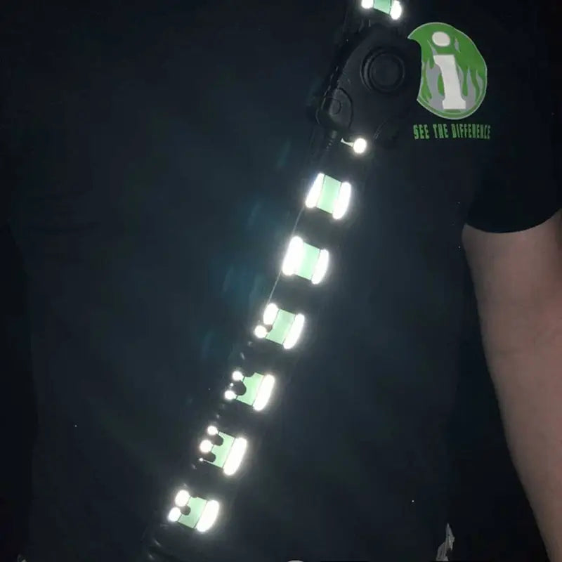 Black t-shirt with reflective silver tabs in Frontline Radio Strap Kit design