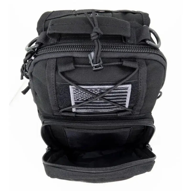 Black tactical backpack with American flag patch, perfect for a Bleeding Control Sling