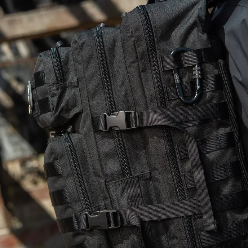 Black M-Tac Assault Pack featuring MOLLE webbing and two large main zippered compartments