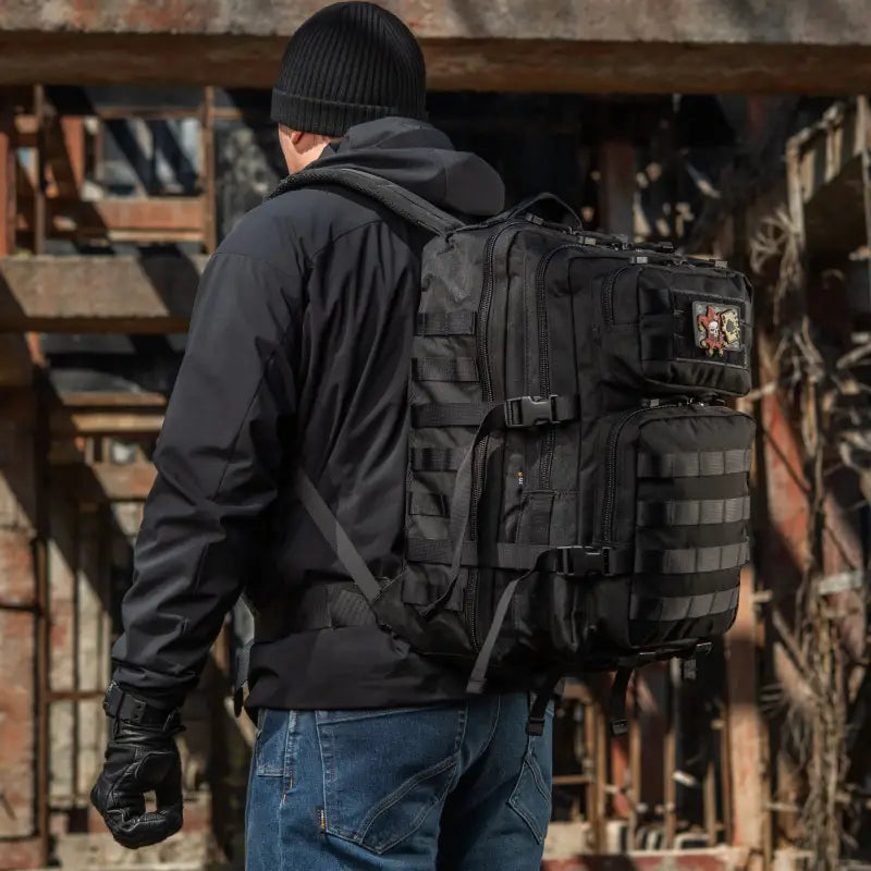 Black M-Tac Assault Pack featuring MOLLE webbing and large main zippered compartments