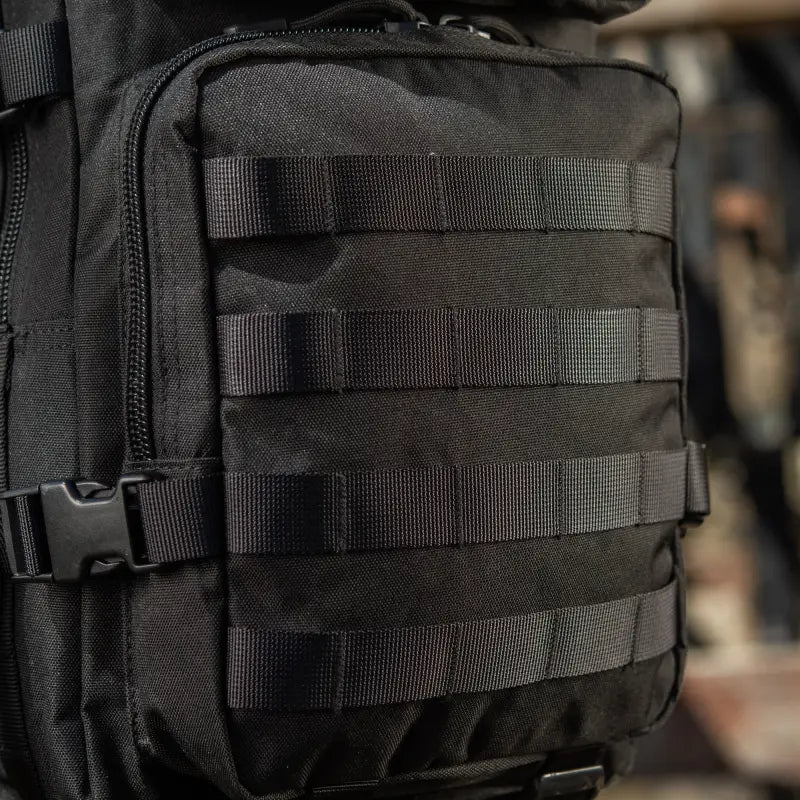 Black M-Tac Assault Pack featuring MOLLE webbing and large main zippered compartments