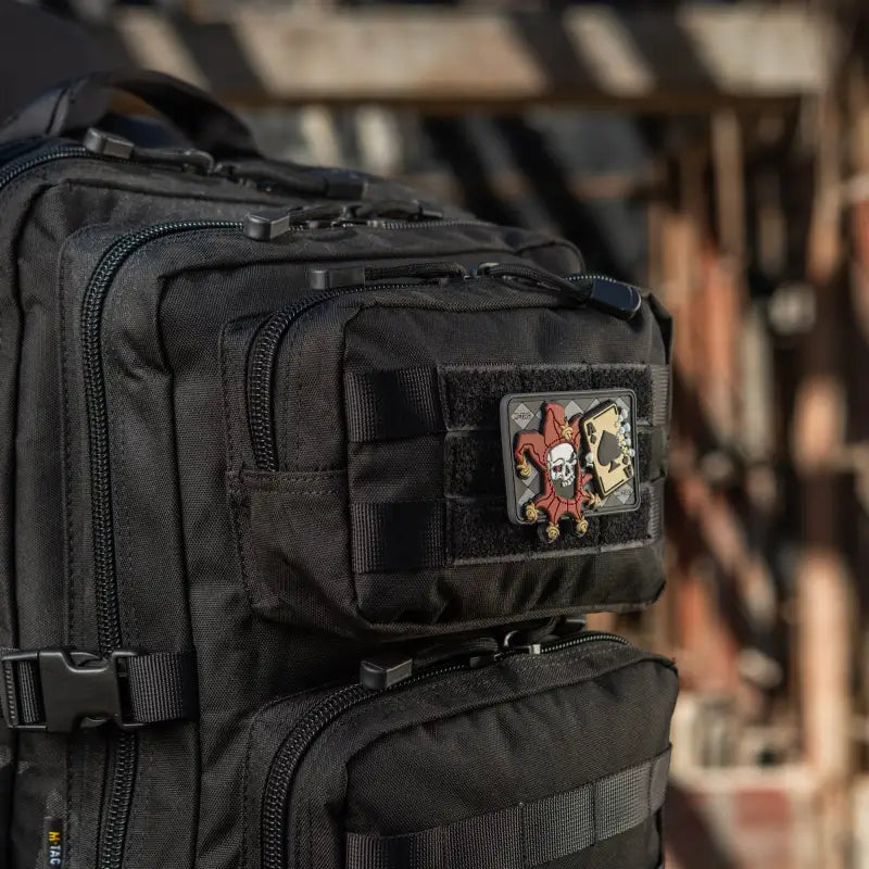 Black tactical M-Tac Assault Pack with two large main zippered compartments and a patch