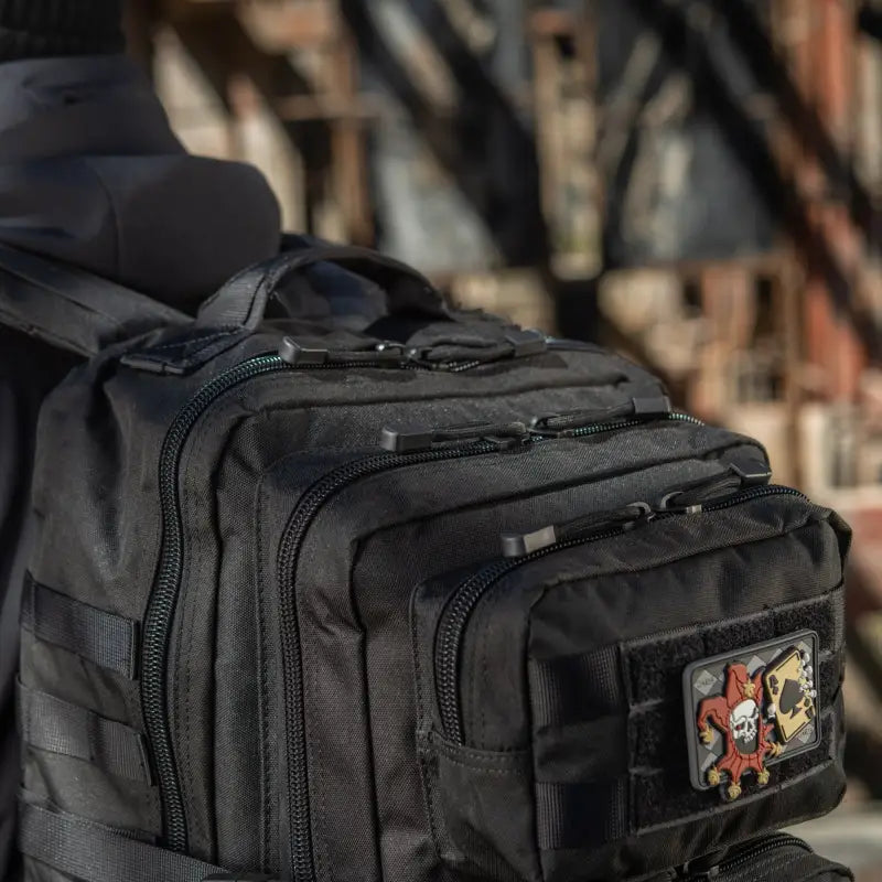 Black M-Tac Assault Pack with two large main zippered compartments and a patch