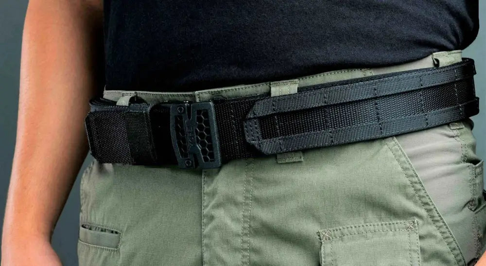 Black tactical battle belt with nylon webbing worn on Ranger Green cargo pants