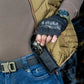 Black tactical fingerless glove gripping holstered firearm, M-Tac Universal Tool Type 2