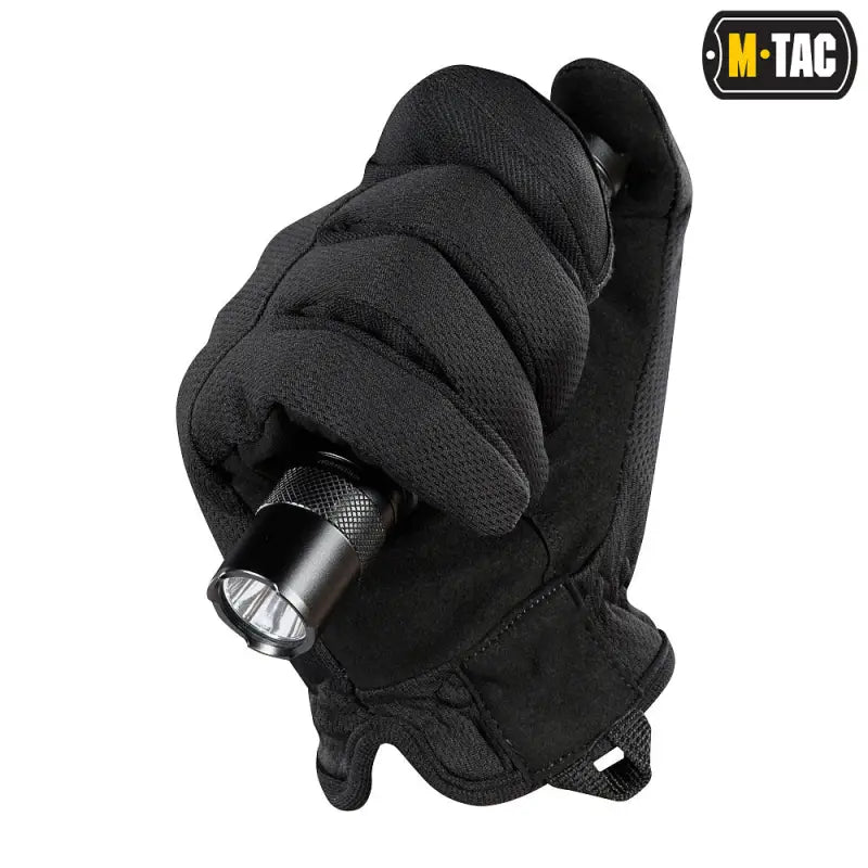 Black synthetic leather M-Tac Gloves Scout Tactical Mk.2 holding a small flashlight