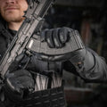 Black M-Tac Gloves Police Gen.2 gripping a firearm magazine for tactical use