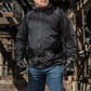 Black tactical jacket with utility belt over blue jeans featuring M-Tac Assault Pack compartments