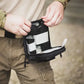 Black tactical medical pouch being opened from the Liberty Gun Pack for easy access