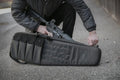 Black tactical Sporting Rifle Case with MOLLE webbing, magazine pouches, and shoulder strap