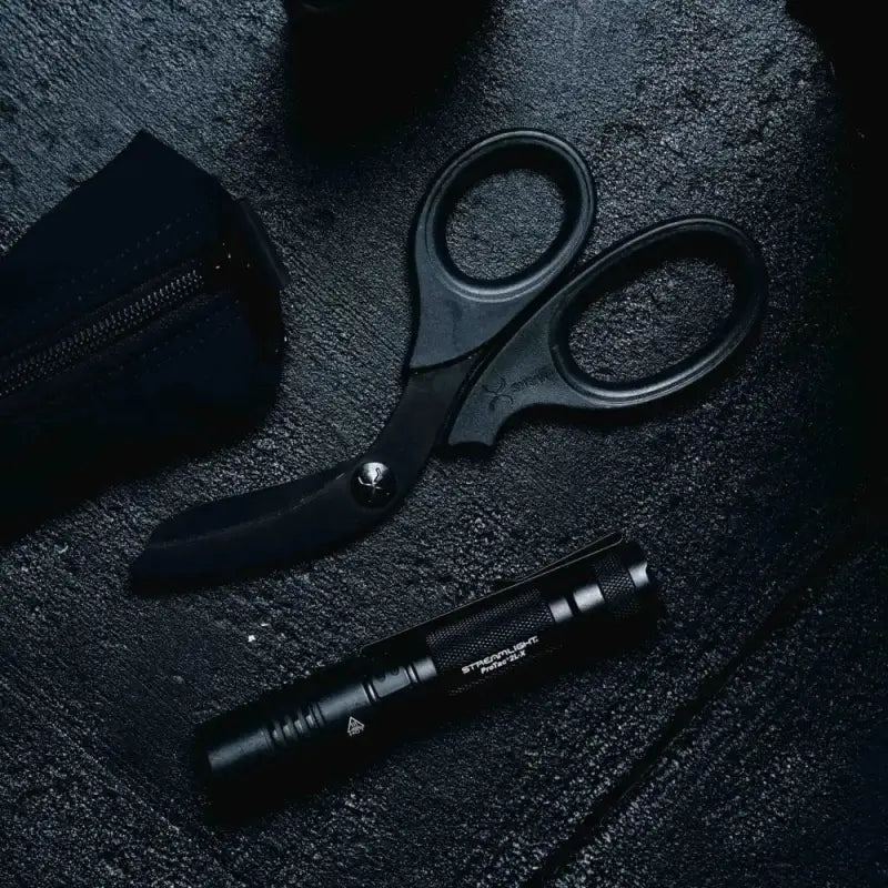 Black tactical scissors and flashlight featuring XShear Heavy Duty Trauma Shears