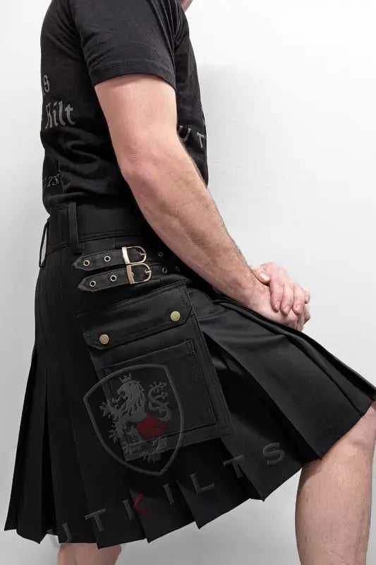 Black utility kilt with decorative buckles and embroidered patch, perfect for everyday wear