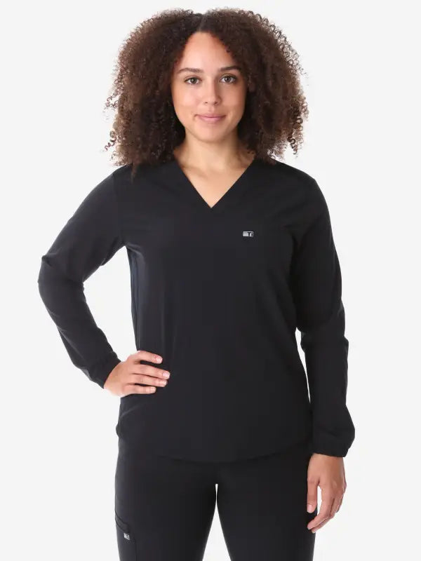 Black v-neck women’s long-sleeve scrub top with long sleeves for comfortable wear