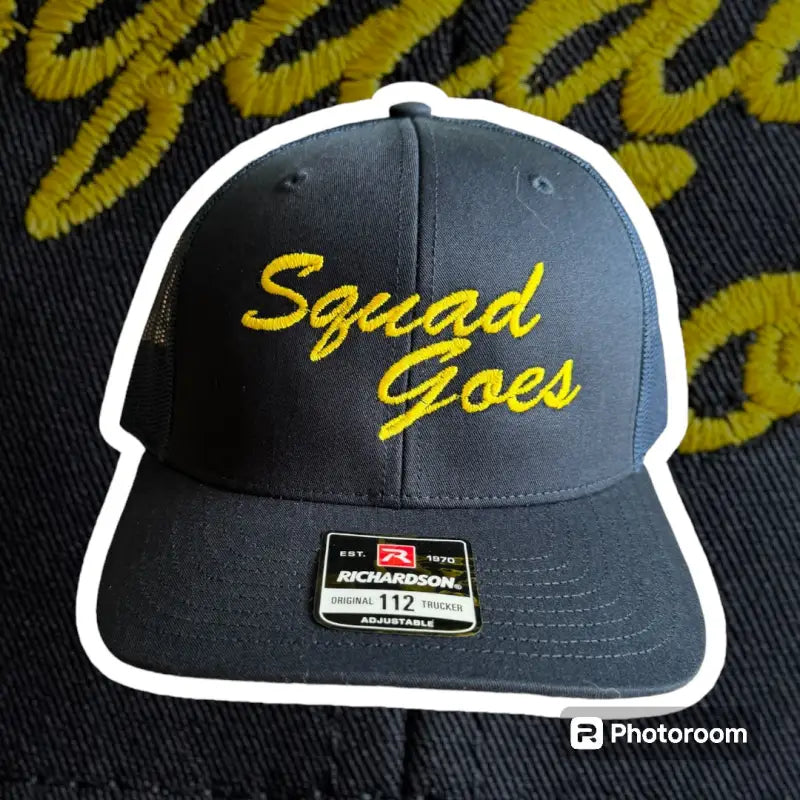 Black and white hat with yellow Squad Goes text for first responders and fans