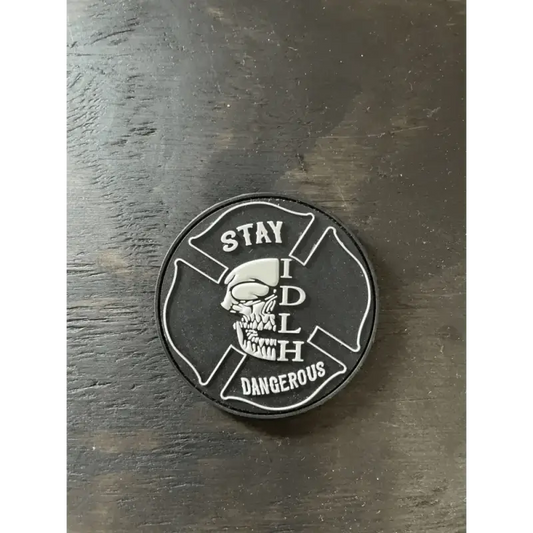 Black and white PVC glow patch with Maltese cross and skull, text reads STAY DANGEROUS