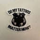 Black and white sticker of a tattooed police uniform asking if tattoos matter now