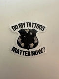 Black and white sticker of a tattooed police uniform asking if tattoos matter now