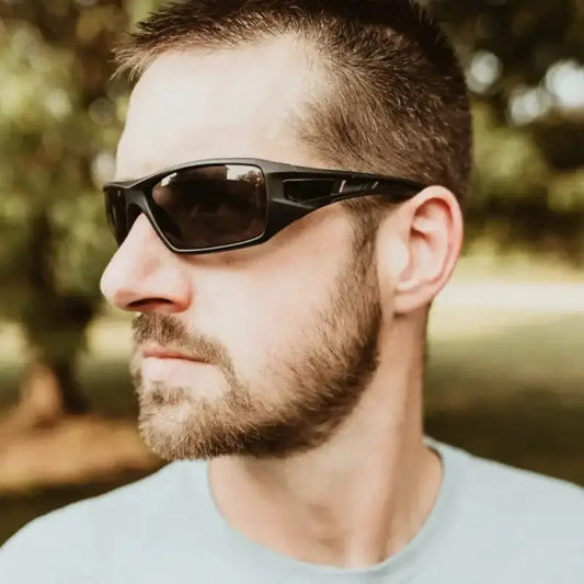 Black wraparound METEL M30 Safety Sunglasses with blue mirror lens worn by a bearded man