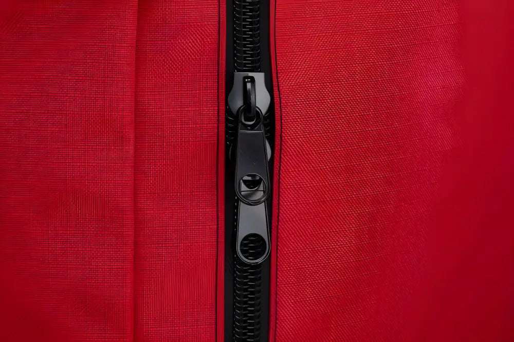 Black zipper detail on red fabric of Deluxe Step-In Firefighter Gear Bag