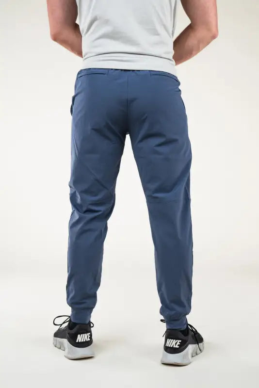 Blue athletic pants featuring Carrier Traveler Joggers with concealed carry technology