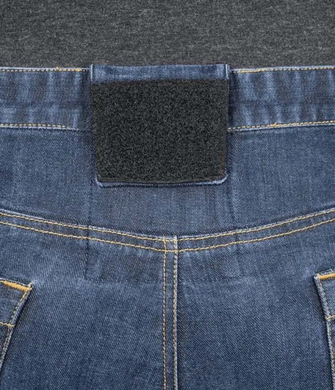 Blue denim Asset Tactical Jeans featuring a black velcro patch on the waistband