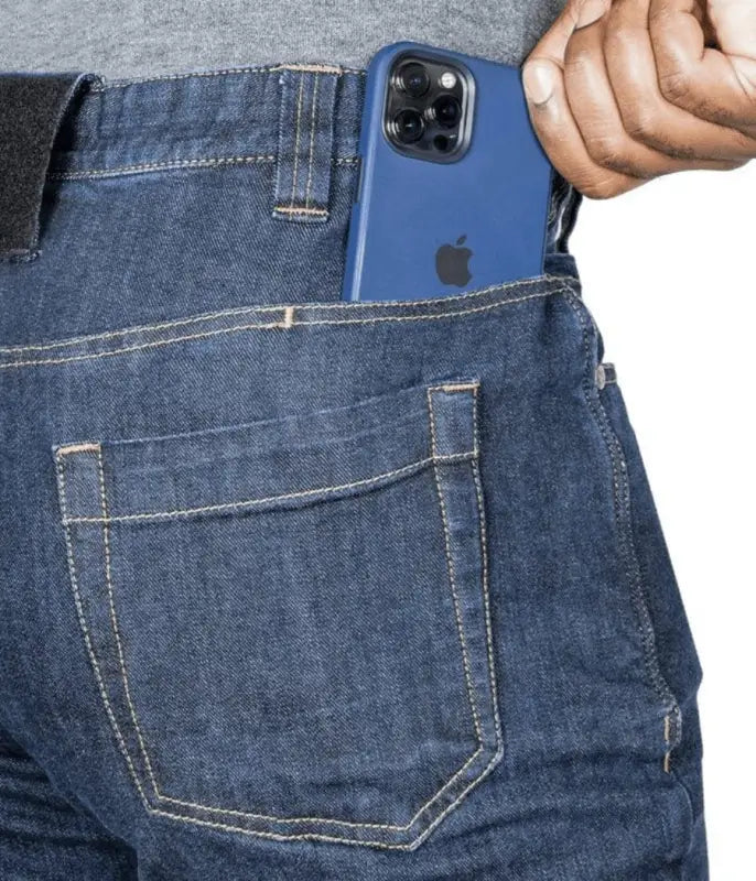 Blue iPhone in a denim jeans pocket of Asset Tactical Jeans showcasing tactical pants features