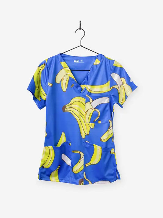 Blue women’s Gone Bananas Scrub Top featuring yellow banana print for first responders