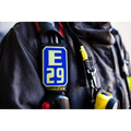 Blue and yellow E29 patch on dark fabric for IdentiFire SCBA Accountability Shoulder Strap System