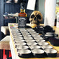 Jack Daniel’s whiskey, mason jars, and skull with Freedom Blend Extra Strong Moustache Wax