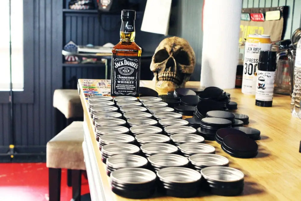 Jack Daniel’s whiskey, mason jars, and skull with Freedom Blend Extra Strong Moustache Wax