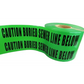 Bright green Barricade Flagging Tape cautioning buried sewer line in hazardous areas