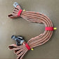 Brown fire hose and metal connectors bundled with a red individual hose strap