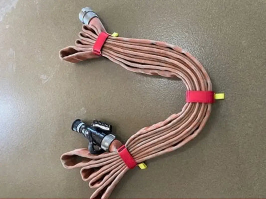 Brown fire hose and metal connectors bundled with a red individual hose strap