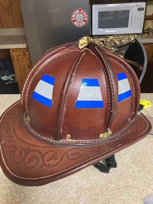 Brown leather firefighter helmet with blue grey triple stripe reflective bands