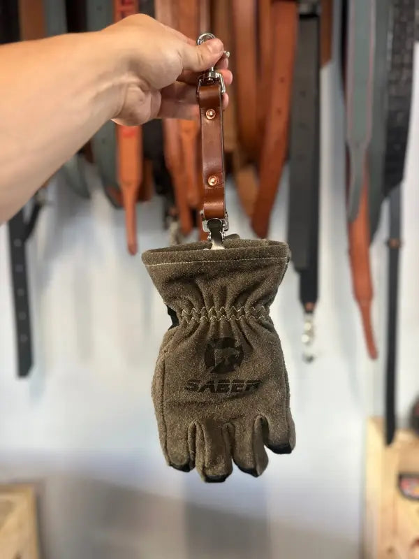 Brown leather firefighter glove-shaped pouch with strap for first responders and police