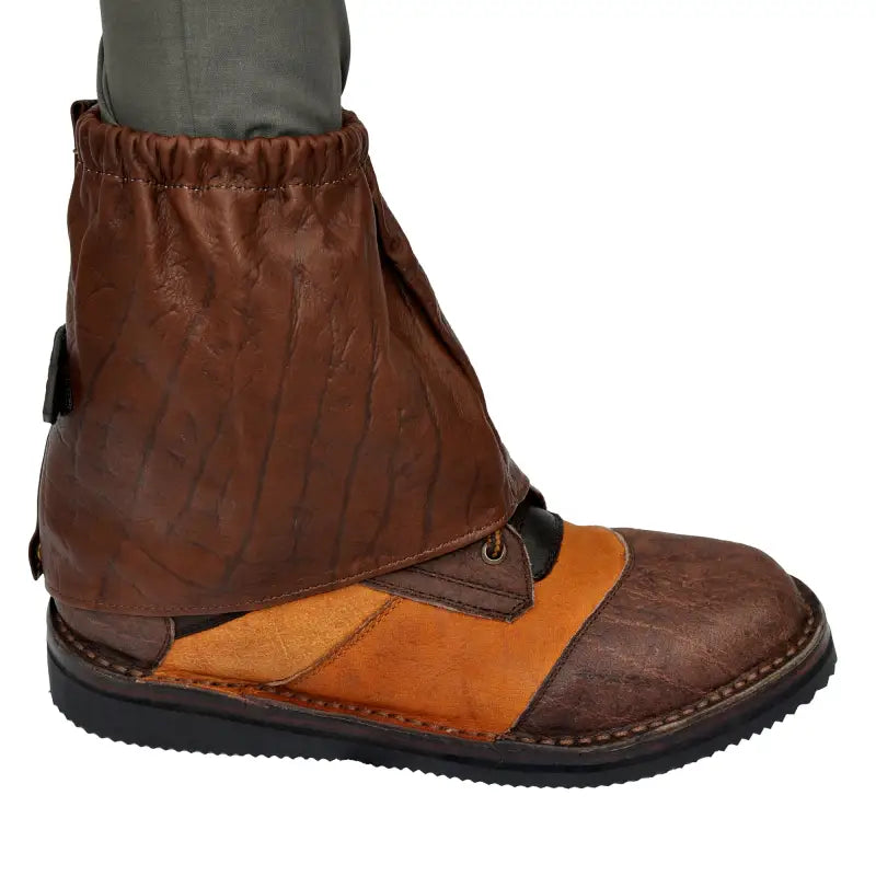 Brown leather Game Skin Ankle Gaiters with orange accent panel on a shoe